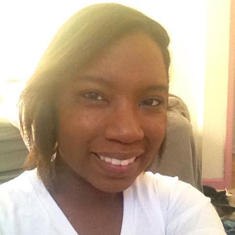 Photo of smiling Black woman taken in warm light