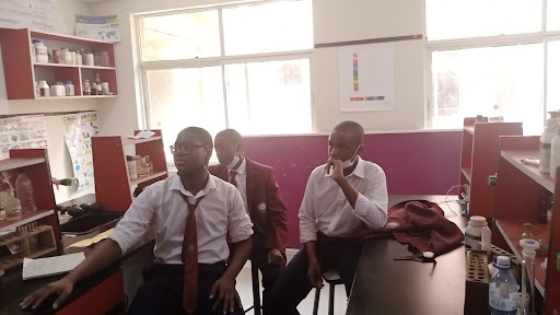 Three students sitting in chairs
