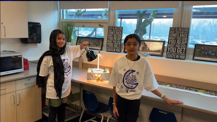 Two students present a prototype for a solar powered streetlight. 