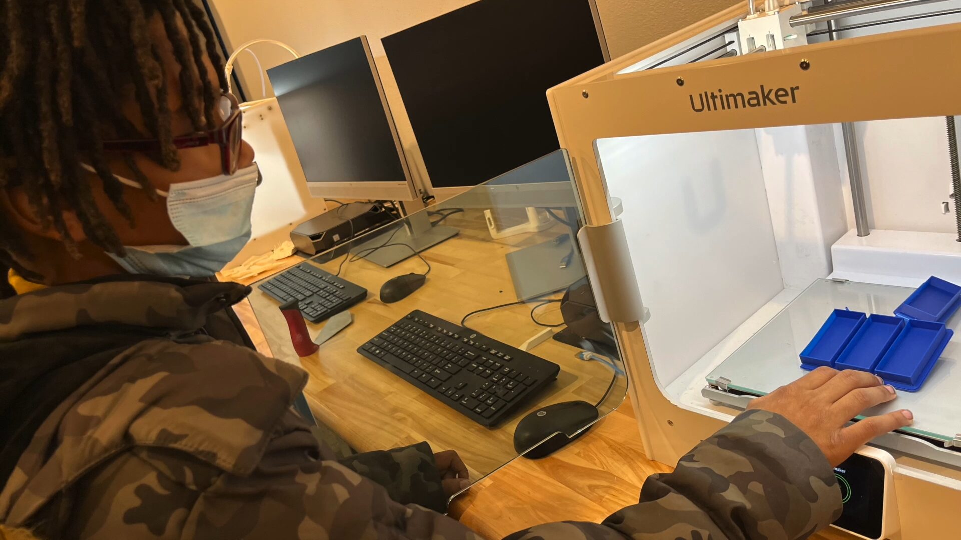 A student looks at their 3D-printed model