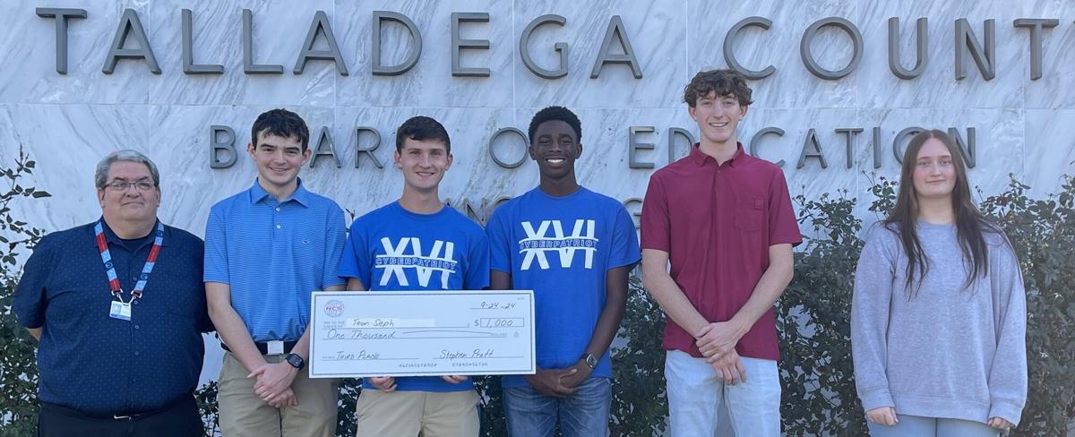 Cybersecurity instructor Brian Kelly (left) and his Lincoln High School students posing with a $1,000 check after winning third place in the National Cyber Summit’s 2024 Cyber Cup. They outperformed several university and professional teams.